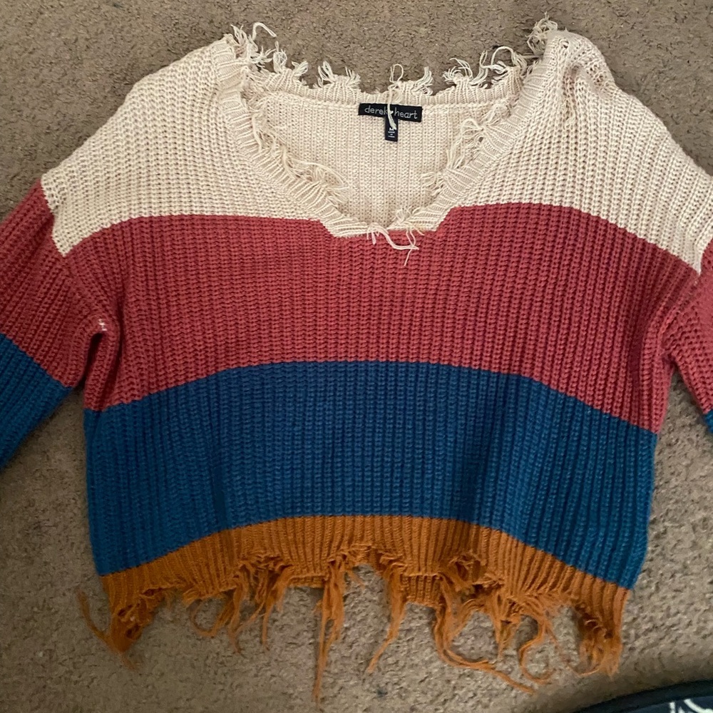 Cropped and distressed long sleeve knitted off the shoulder sweater